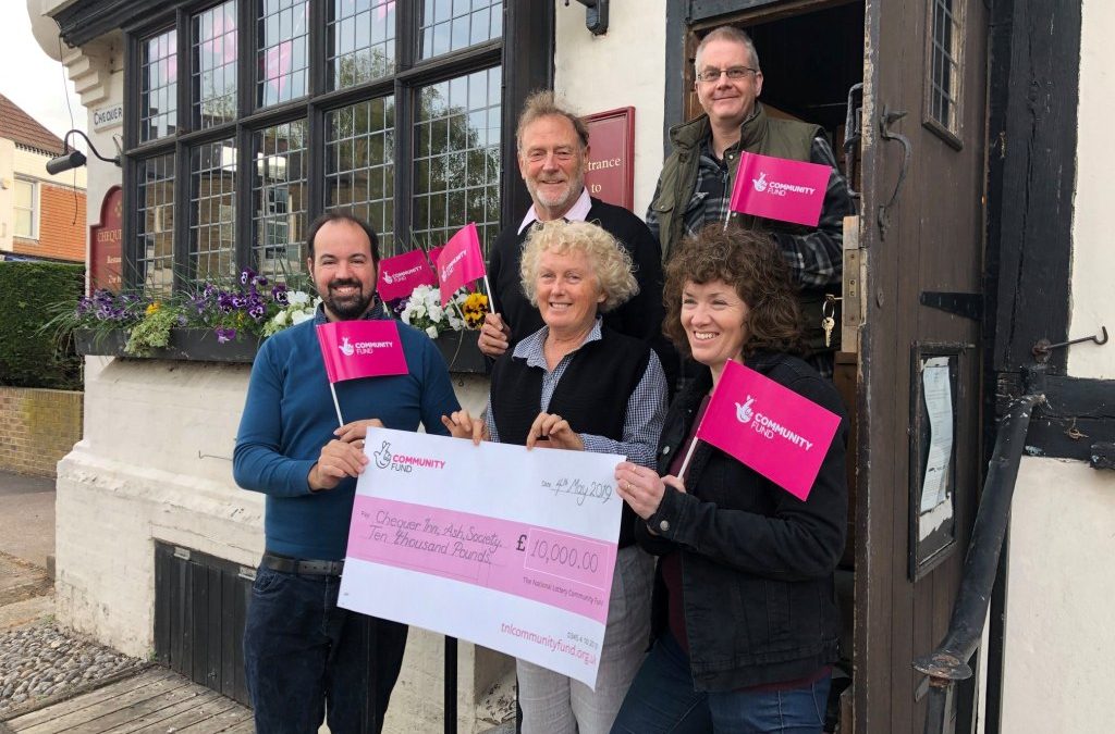 Committee Members Celebrating Lottery funding award in front of the Chequer Inn
